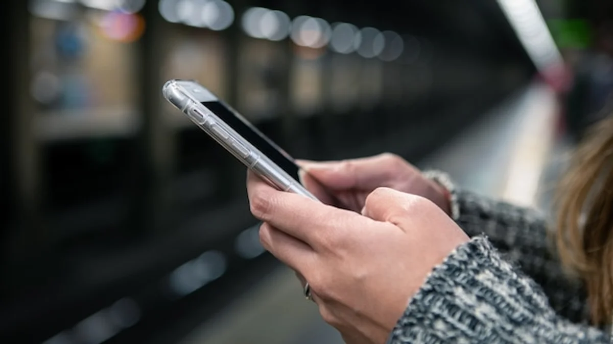 check phone social media scrolling public transport