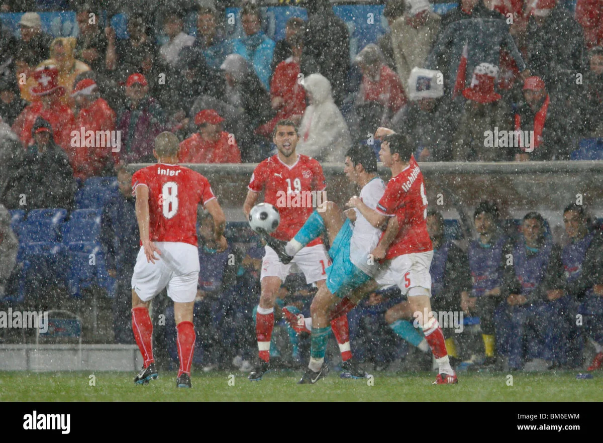 intense autumn football match Europe rain