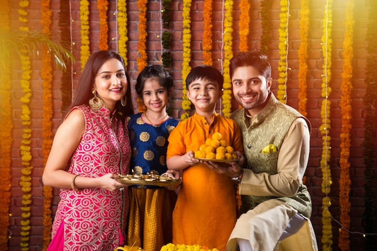 indian family celebrating diwali sweets lights