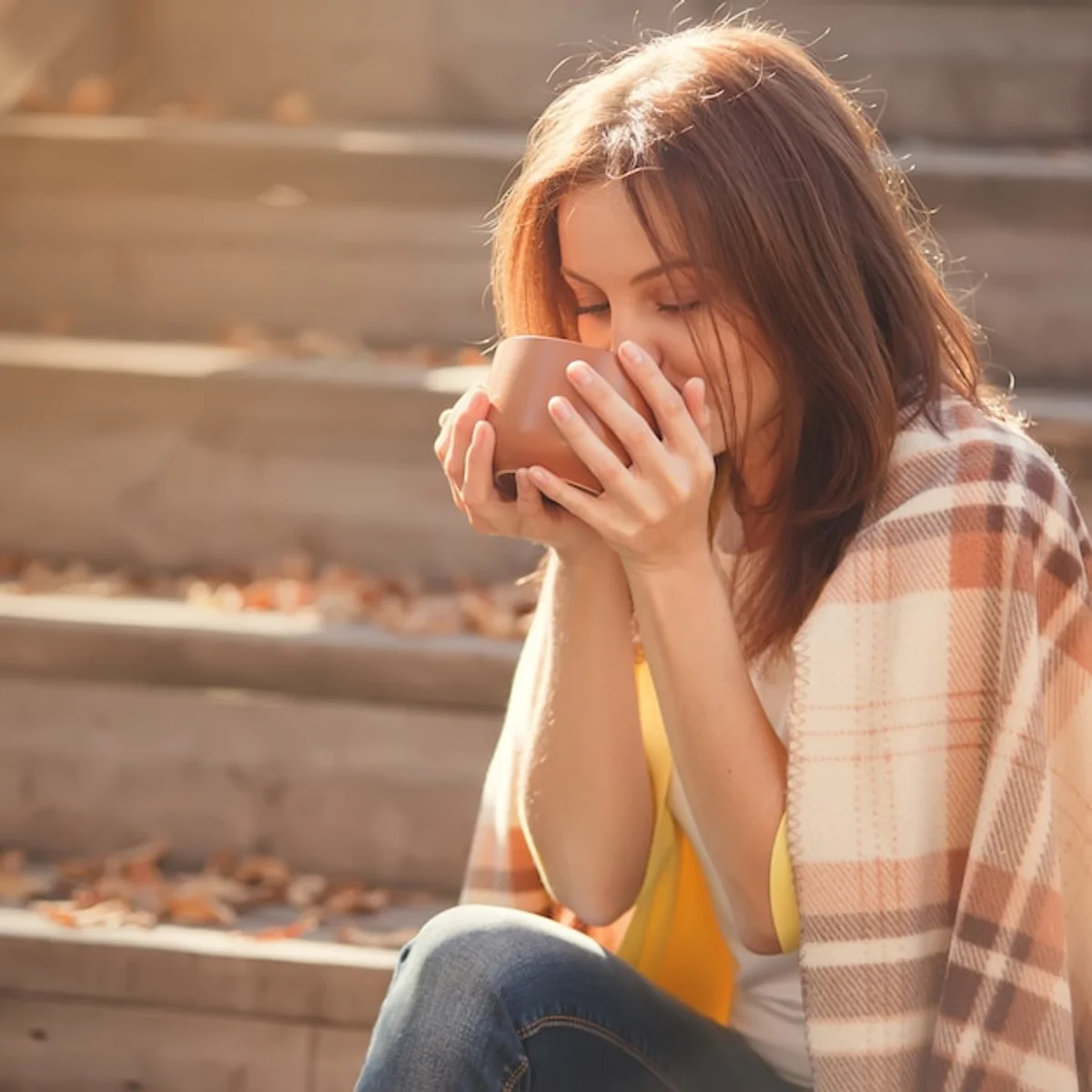 woman tired blanket autumn window