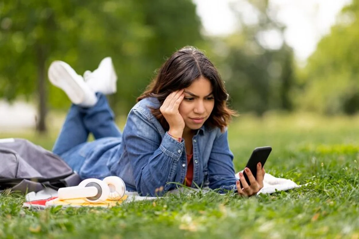 relaxing in nature while using smartphone stressed