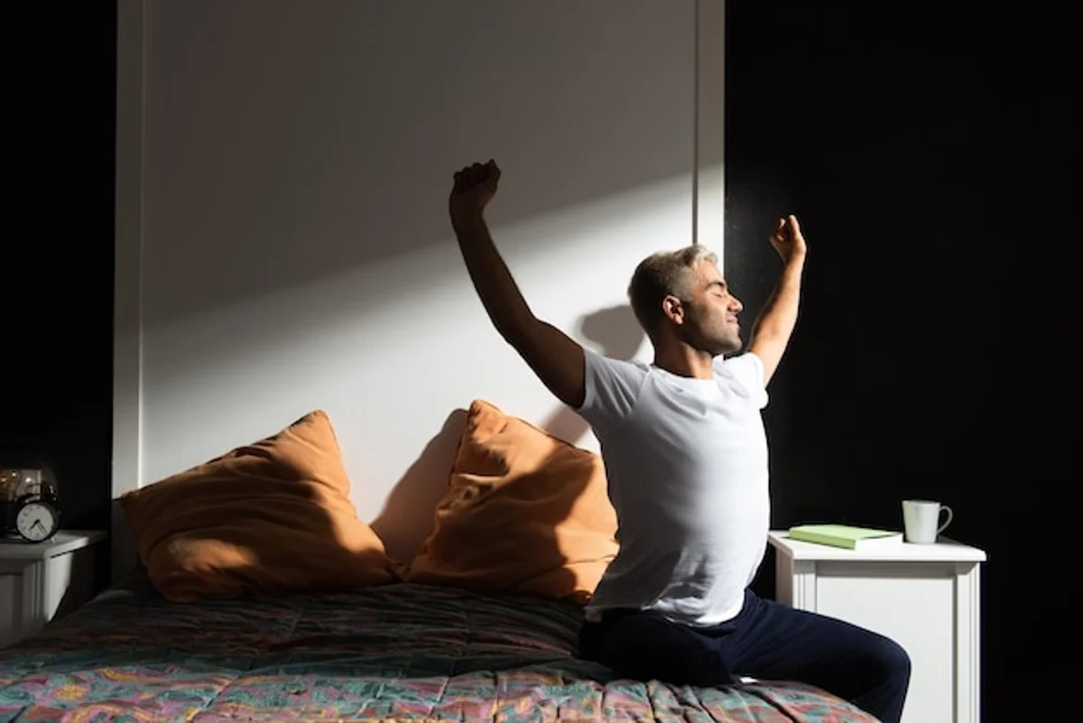 person stretching morning routine in bedroom