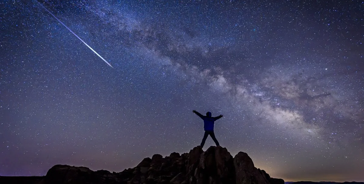 friends watching meteor shower on autumn night in Czech Republic