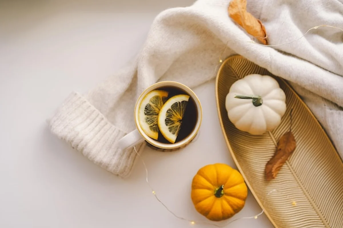 sliced lemon next to autumn vegetables on rustic background
