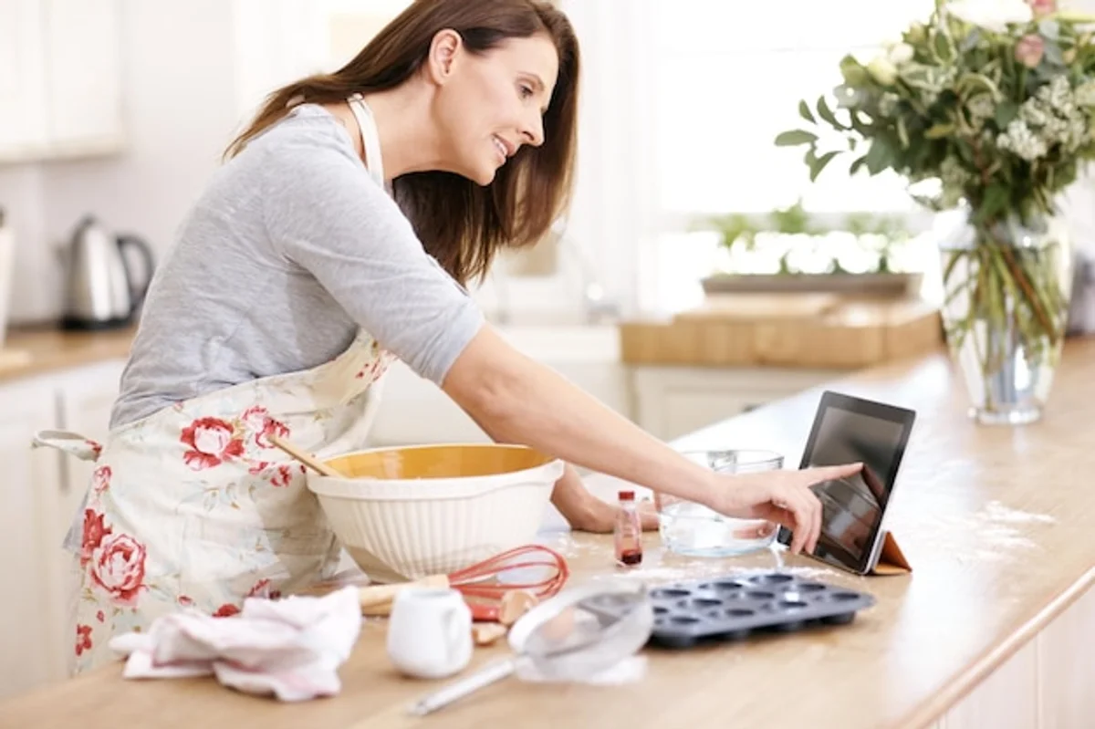 woman using cooking app tablet home kitchen