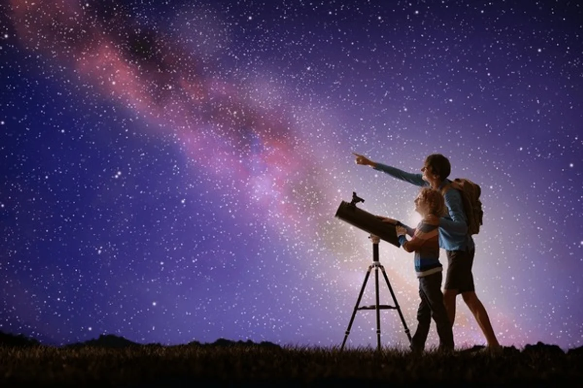 family observing saturn with telescope garden autumn