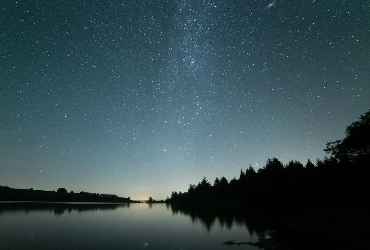 starry sky meteor above forest November Europe