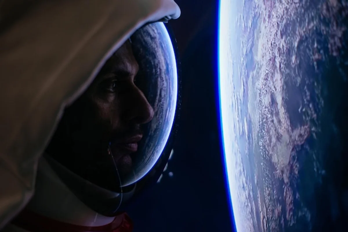 astronaut looking at earth from space window mindfulness universe