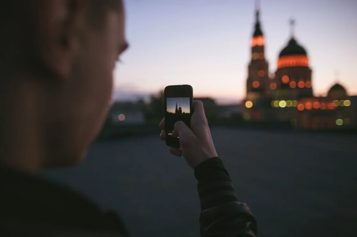 person using smartphone in bed at night Prague winter