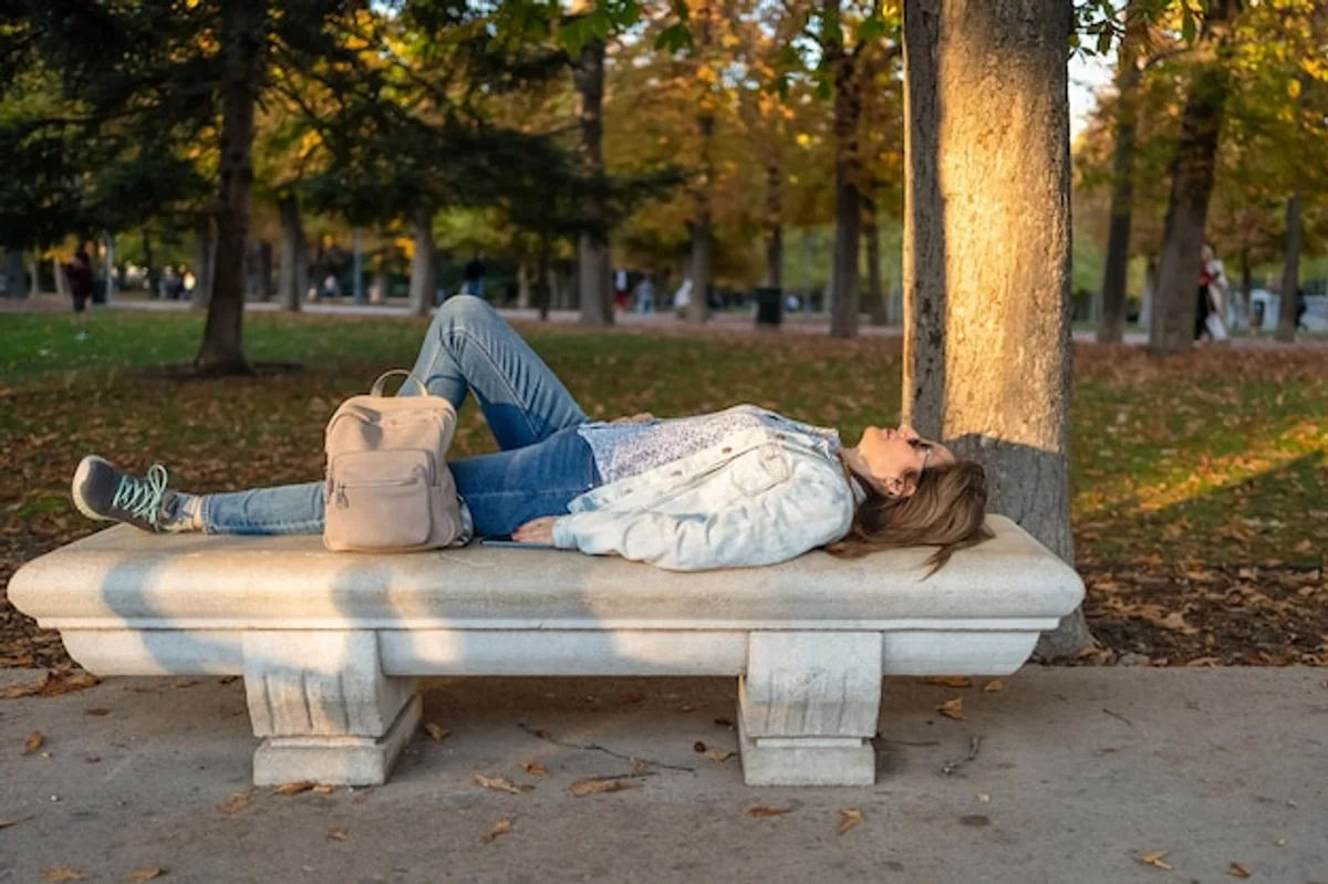 tired caucasian woman autumn city park